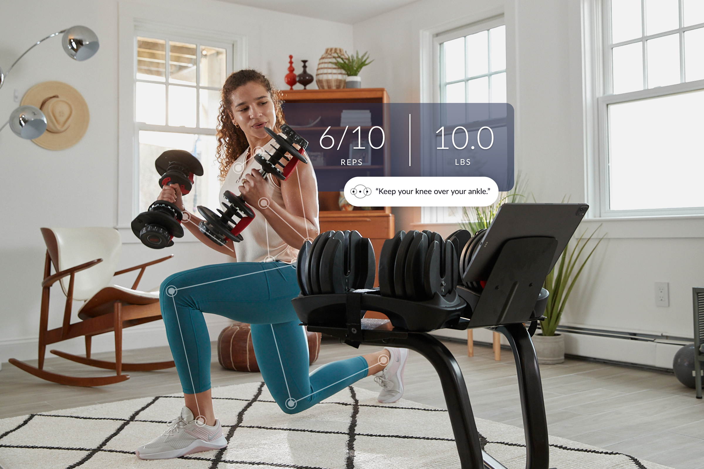 A woman holding Bowflex weights with an overlay of stats being counted by the Nautilus a JRNY app designed by Supply. The picture includes some text of the app telling the woman to "Keep your knee over your ankle"